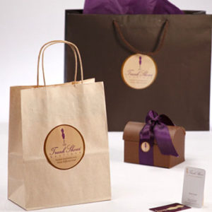 several paper bags and a small box with a paper on them