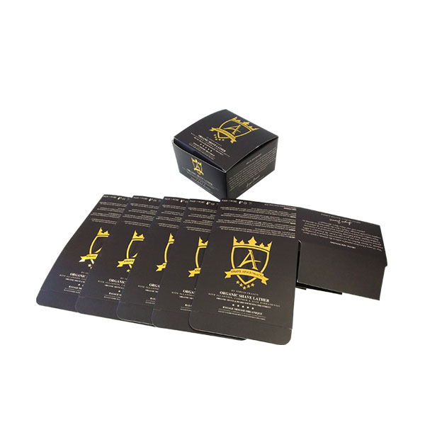 a group of black cosmetic boxes with yellow logo
