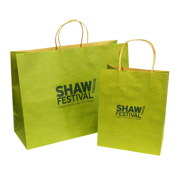 a pair of green paper bags with black text on them