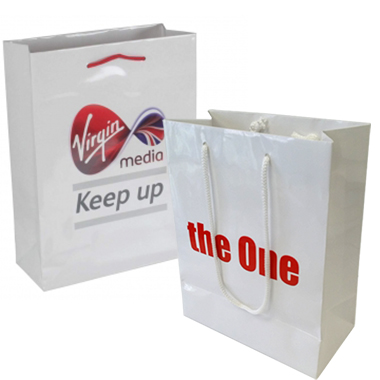 two white paper shopping bags with red text