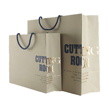 a group of laminated paper shopping bags with foil hot stamped logo on the right