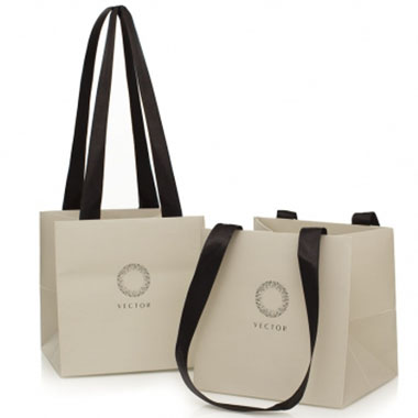 a pair of white laminated paper bags with black ribbon handles