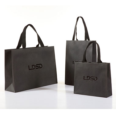 several black laminated paper bags with spot uv logo