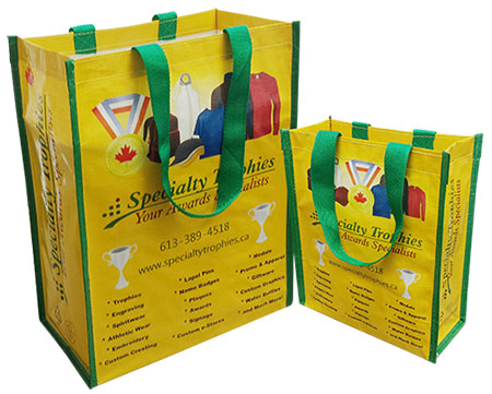 a pair of yellow laminated reusable shopping bags with green handle
