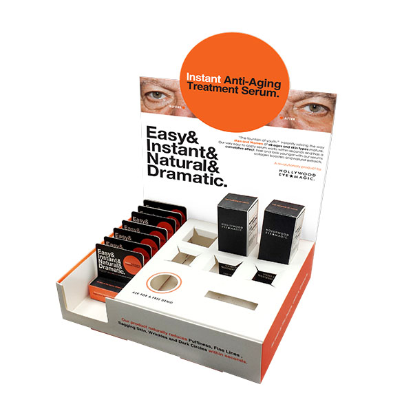 a white display box with black cosmetic boxes and a label